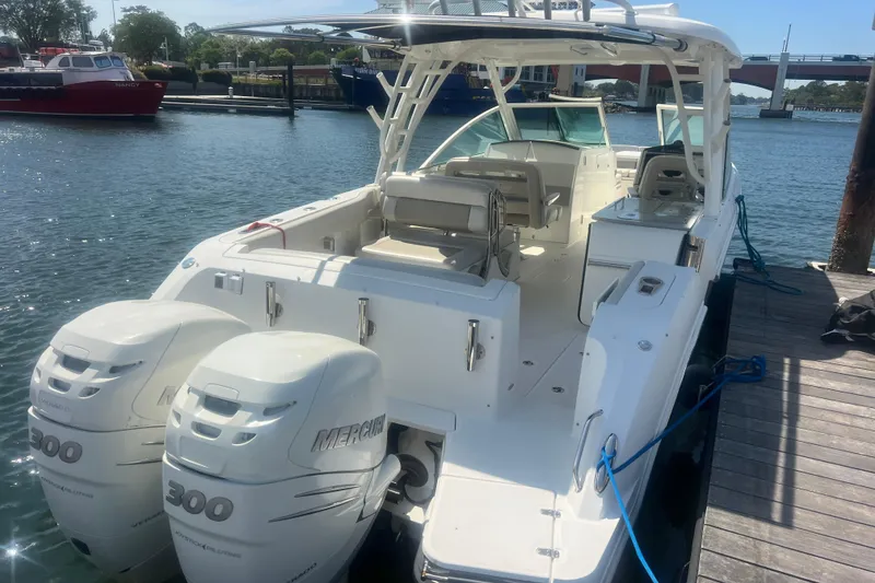 Slide: The Image of 2015 Boston Whaler 320 Vantage boat docked with twin Mercury 300 engines. - 2