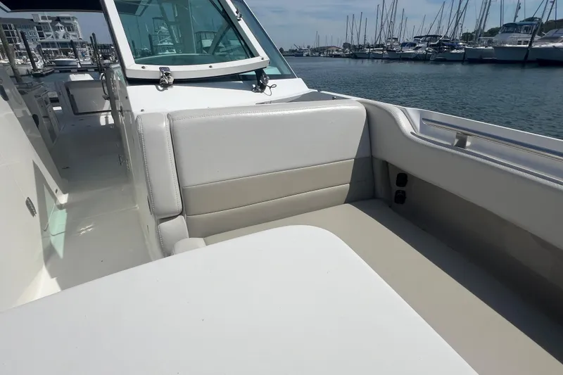 Slide: The Image of 2015 Boston Whaler 320 Vantage boat interior with seating, docked at marina. - 20
