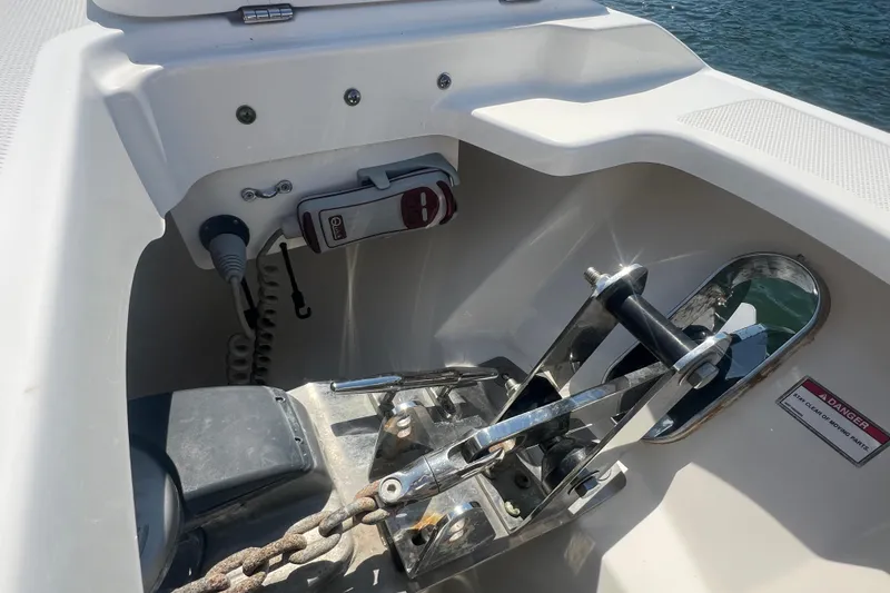 Slide: The Image of Anchor system on a 2015 Boston Whaler 320 Vantage boat, featuring a secure chain mechanism. - 23