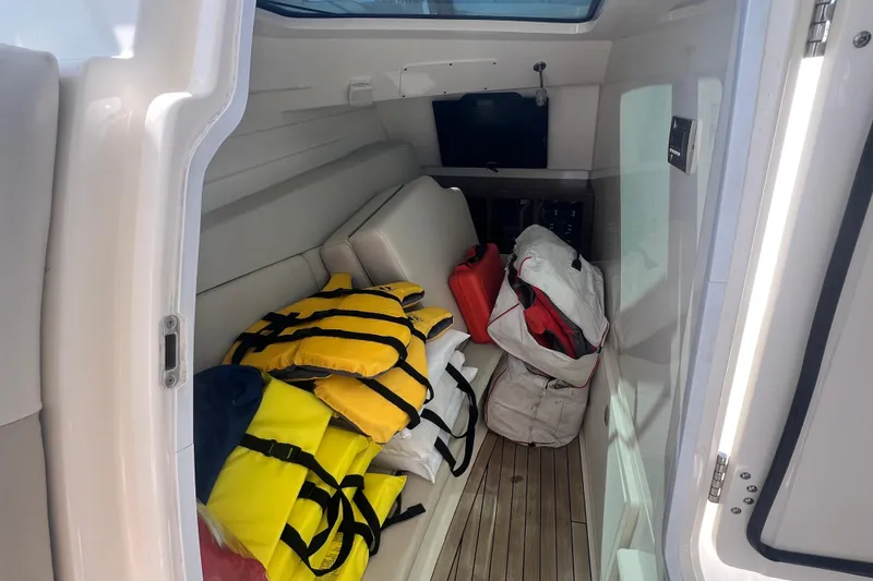 Slide: The Image of Interior cabin of 2015 Boston Whaler 320 Vantage with life jackets and gear. - 28