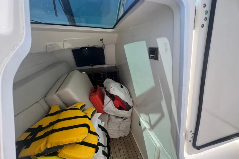 Slide: The Image of Interior cabin of 2015 Boston Whaler 320 Vantage with life jackets and storage. - 30