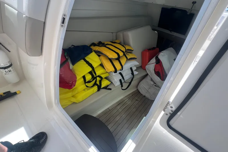 Slide: The Image of Interior cabin of 2015 Boston Whaler 320 Vantage with life jackets and gear. - 31