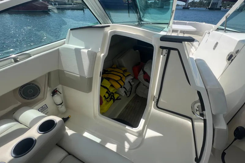 Slide: The Image of Interior view of a 2015 Boston Whaler 320 Vantage boat with life jackets stored inside. - 32
