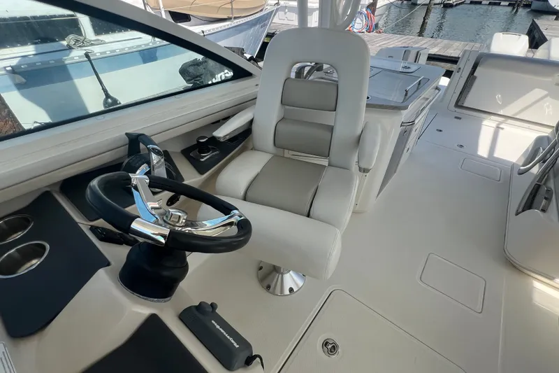 Slide: The Image of 2015 Boston Whaler 320 Vantage helm with steering wheel and captain's chair. - 34