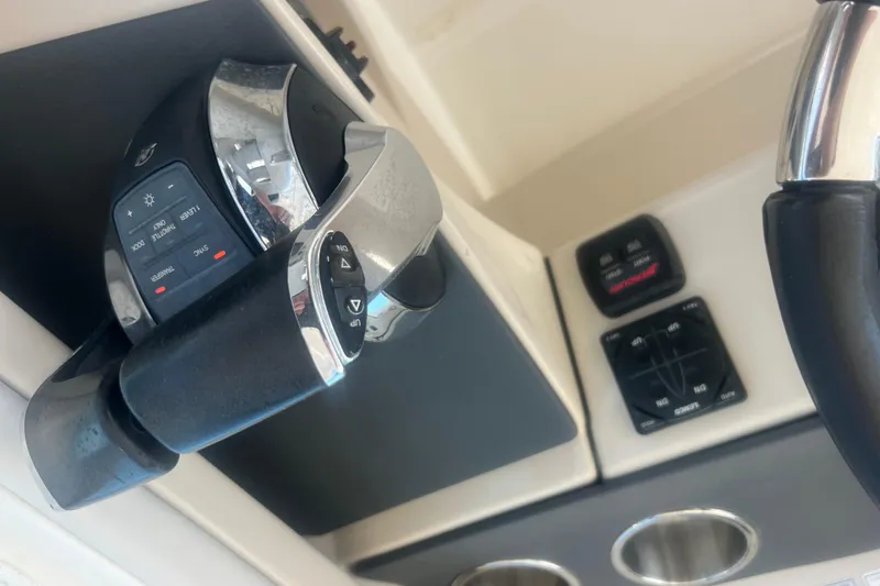 Slide: The Image of Control panel of a 2015 Boston Whaler 320 Vantage boat, featuring throttle and navigation controls. - 39