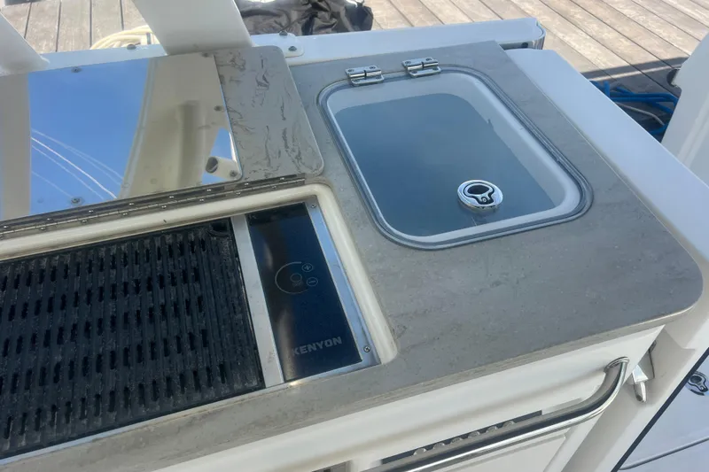 Slide: The Image of Boston Whaler 320 Vantage 2015 boat kitchen area with sink and grill. - 41