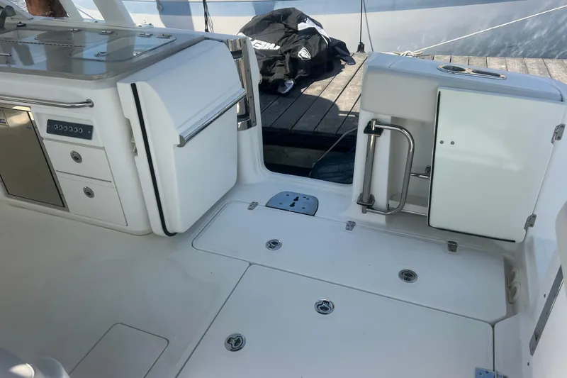 Slide: The Image of 2015 Boston Whaler 320 Vantage boat interior with storage compartments and sleek design. - 48