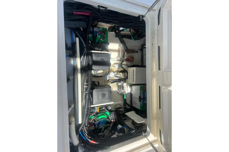 Slide: The Image of Engine compartment of a 2015 Boston Whaler 320 Vantage, showcasing wiring and components. - 49