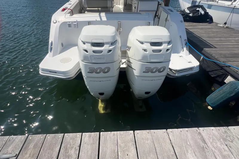 Slide: The Image of 2015 Boston Whaler 320 Vantage with twin 300 horsepower engines docked at marina. - 5