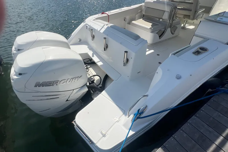 Slide: The Image of 2015 Boston Whaler 320 Vantage with dual Mercury engines docked by the water. - 6
