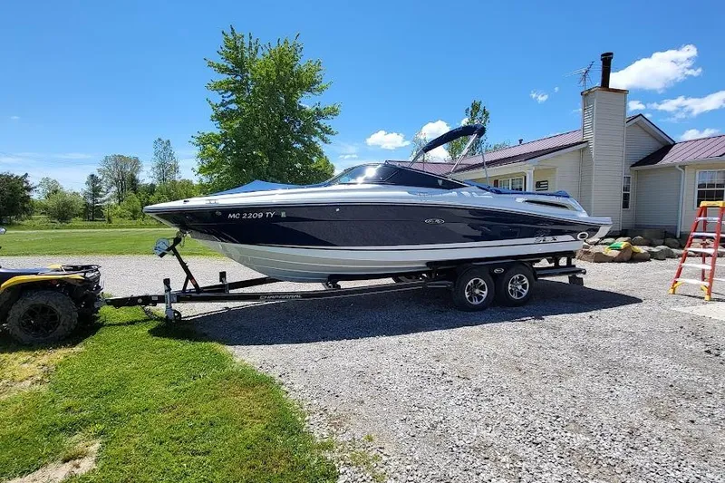 The Image of 2016 Sea Ray SLX 250 boat on trailer, parked outdoors on a sunny day. - 0