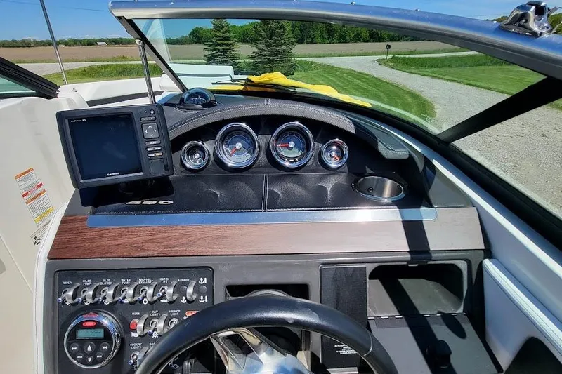 Slide: The Image of Dashboard of a 2016 Sea Ray SLX 250 boat with gauges and controls. - 11