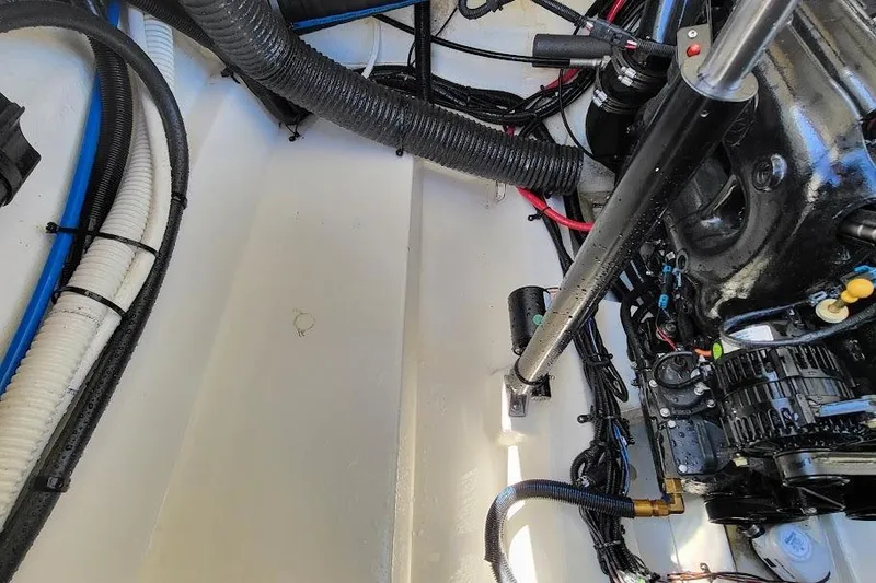 Slide: The Image of Engine compartment of a 2016 Sea Ray SLX 250 boat, showing cables and components. - 13