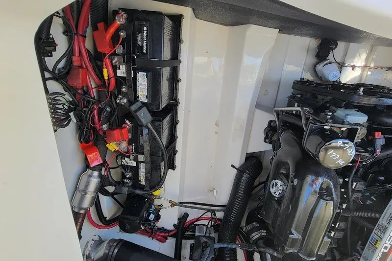 Slide: The Image of Engine compartment of a 2016 Sea Ray SLX 250 boat, showing batteries and wiring. - 14