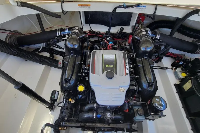 Slide: The Image of Engine compartment of a 2016 Sea Ray SLX 250 boat, showcasing the motor and components. - 15