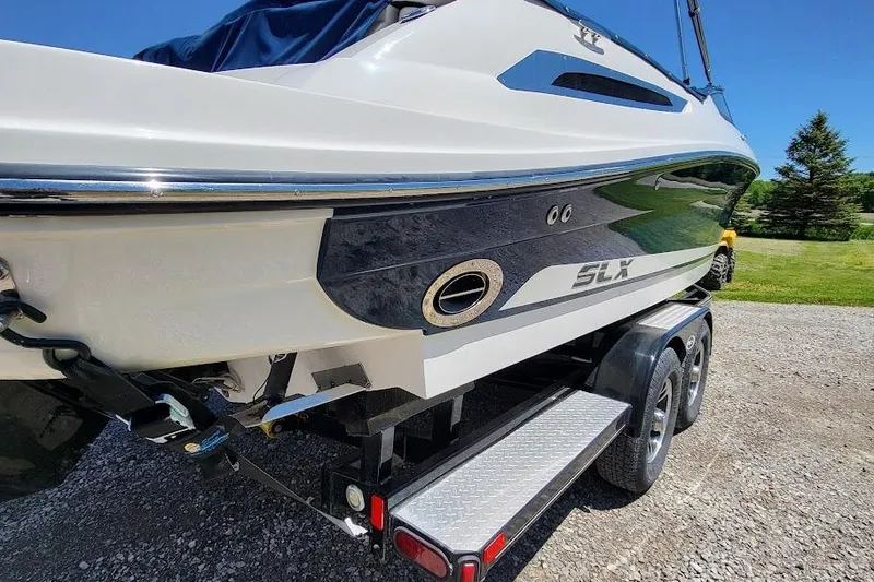 Slide: The Image of 2016 Sea Ray SLX 250 boat on trailer, side view, outdoors. - 2