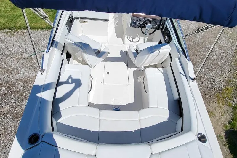 Slide: The Image of 2016 Sea Ray SLX 250 boat interior with white seating and steering console. - 4