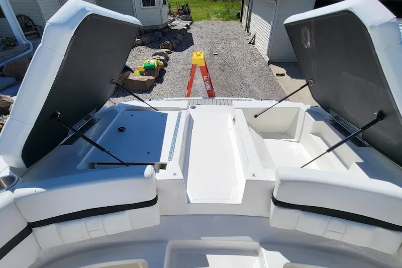 Slide: The Image of 2016 Sea Ray SLX 250 boat with open storage compartments on deck. - 8