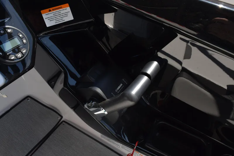 Slide: The Image of Control panel and throttle of 2026 Yamaha Boats AR220, featuring warning label and digital display. - 21