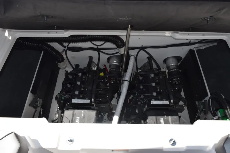 Slide: The Image of Engine compartment of a 2026 Yamaha Boats AR220, showcasing dual engines and wiring. - 24