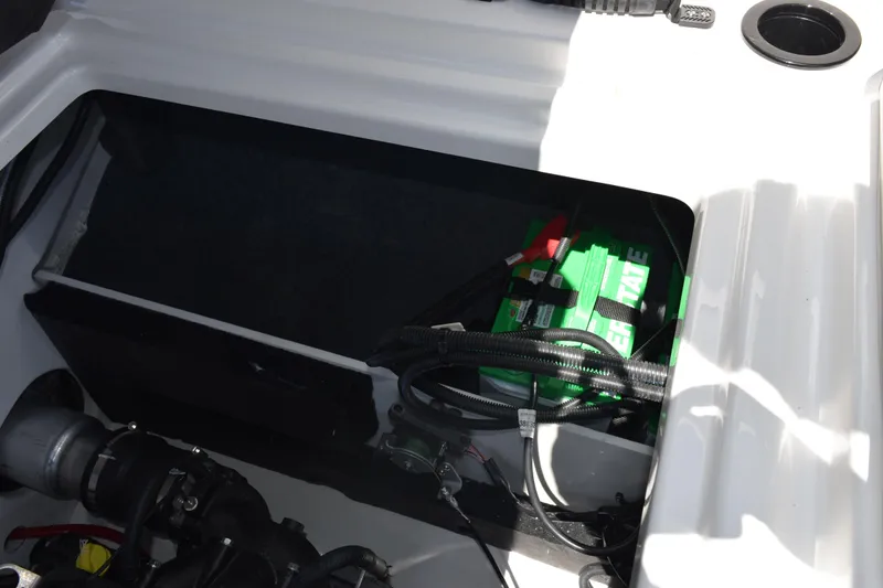 Slide: The Image of Battery compartment of 2026 Yamaha Boats AR220, showcasing wiring and components. - 26