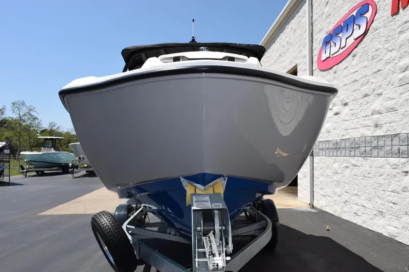 Slide: The Image of 2026 Yamaha Boats AR220 on trailer, parked outside dealership under clear blue sky. - 3