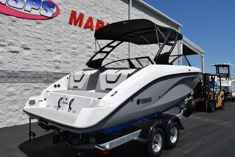 Slide: The Image of 2026 Yamaha Boats AR220 on trailer, displayed outside a marine dealership. - 4