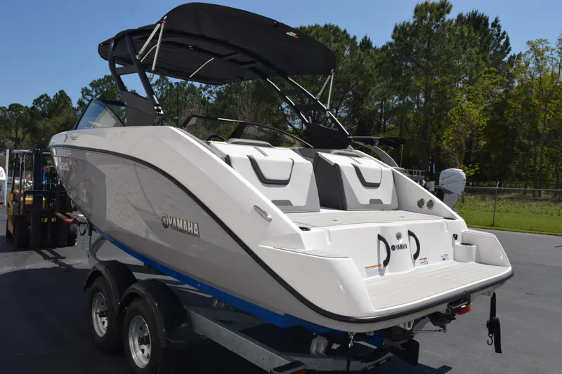 Slide: The Image of 2026 Yamaha Boats AR220 on trailer, featuring sleek design and spacious seating. - 6