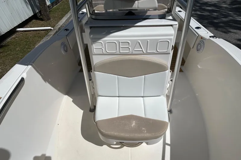 Slide: The Image of 2018 Robalo R180 Center Console boat interior with cushioned seating and console details. - 10