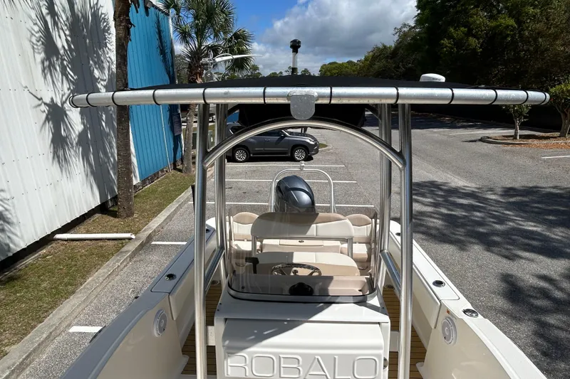 Slide: The Image of 2018 Robalo R180 Center Console boat parked, showcasing sleek design and spacious interior. - 11