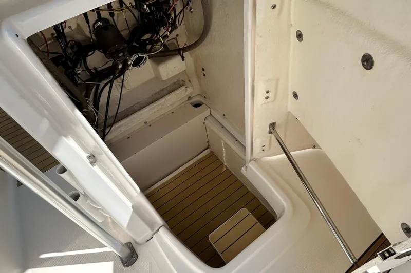 Slide: The Image of 2018 Robalo R180 Center Console boat interior wiring and storage compartment. - 12