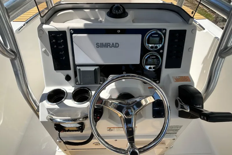 Slide: The Image of 2018 Robalo R180 Center Console dashboard with Simrad display and Yamaha controls. - 13