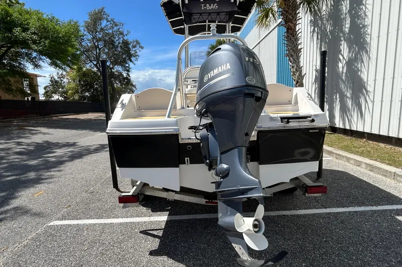 Slide: The Image of 2018 Robalo R180 Center Console boat with Yamaha outboard motor, parked outdoors. - 4
