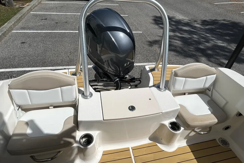 Slide: The Image of 2018 Robalo R180 Center Console boat interior with seating and outboard motor. - 7