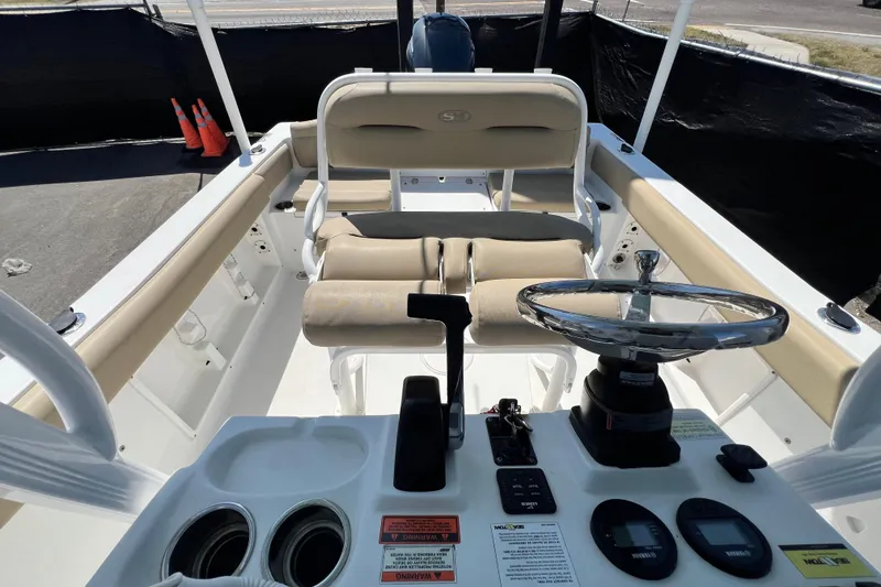 Slide: The Image of 2016 Sea Hunt Ultra 211 boat interior with steering wheel and seating. - 101