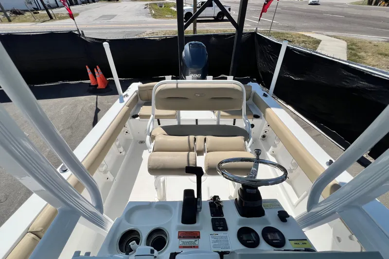 Slide: The Image of 2016 Sea Hunt Ultra 211 boat interior with steering wheel and seating. - 102