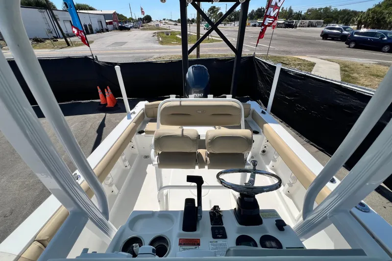 Slide: The Image of 2016 Sea Hunt Ultra 211 boat interior with steering wheel and seating. - 103