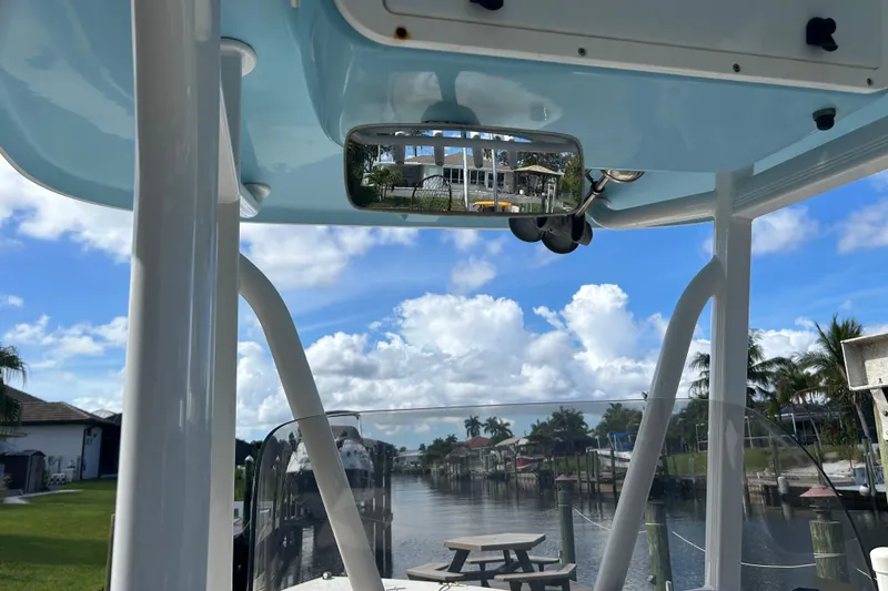 Slide: The Image of 2016 Sea Hunt Ultra 211 boat with 200 horsepower engine at a marina. - 11