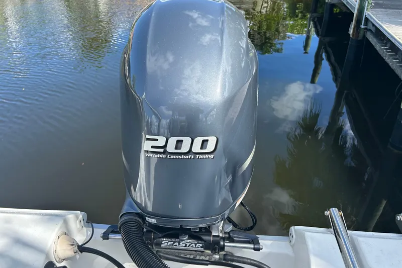 Slide: The Image of Yamaha four-stroke engine on a 2016 Sea Hunt Ultra 211 boat under clear skies. - 15