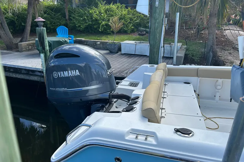 Slide: The Image of Trailer wheels of a 2016 Sea Hunt Ultra 211 boat on pavement. - 2