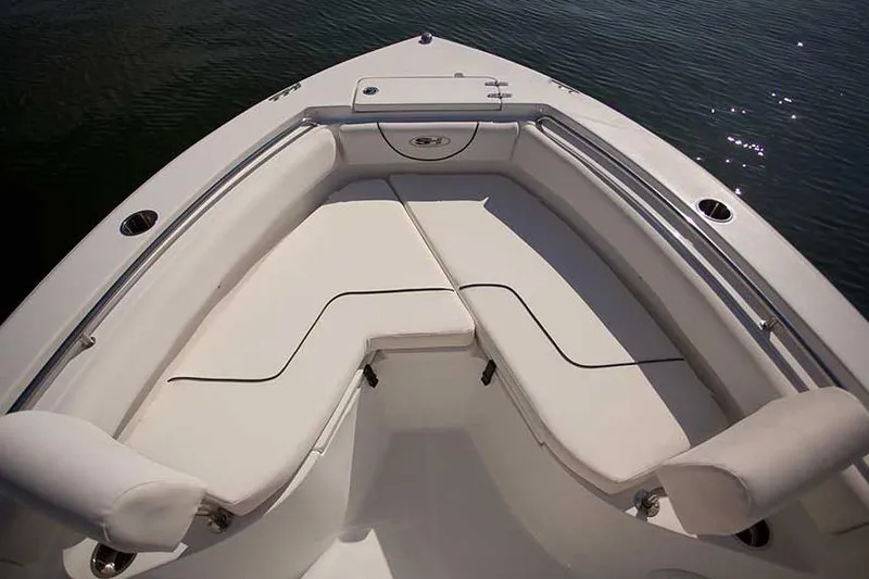 Slide: The Image of 2016 Sea Hunt Ultra 211 boat on trailer at dealership under clear blue sky. - 22