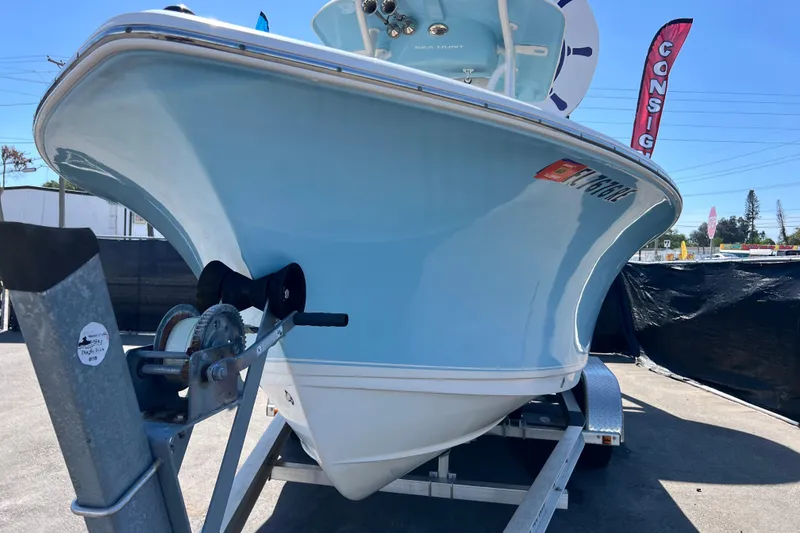 Slide: The Image of 2016 Sea Hunt Ultra 211 boat on trailer, light blue hull, outdoor display. - 26