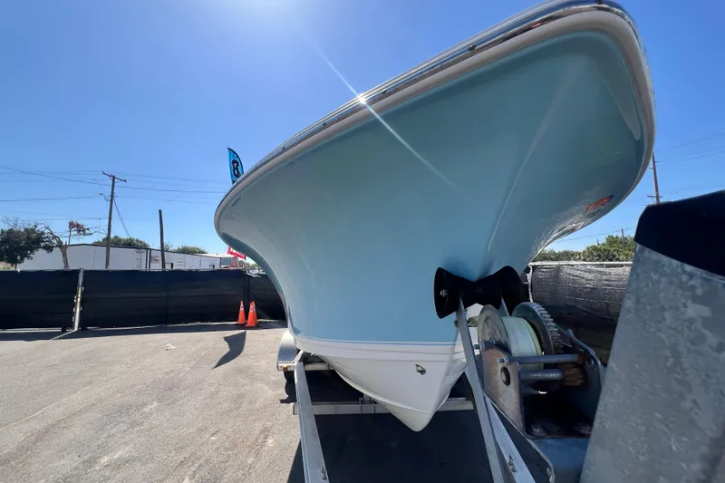 Slide: The Image of 2016 Sea Hunt Ultra 211 boat on trailer under clear blue sky. - 29