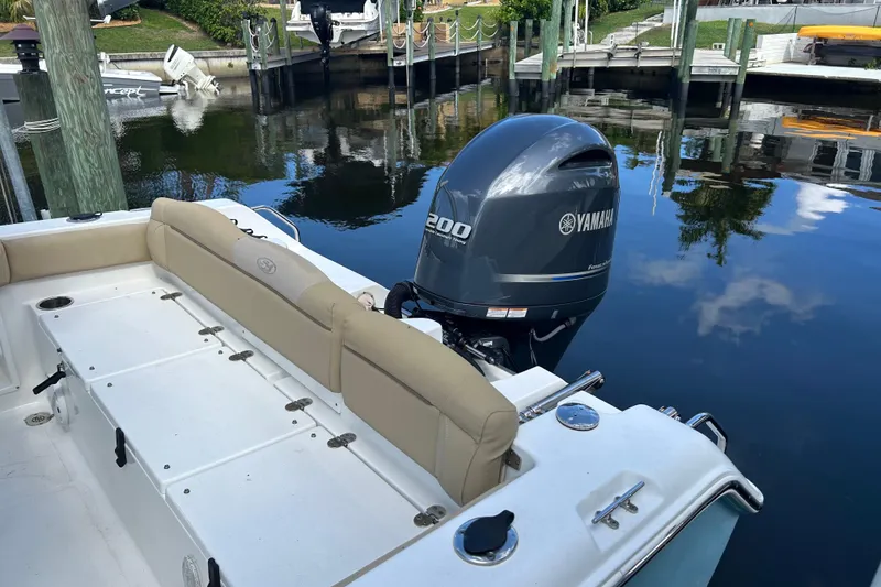 Slide: The Image of 2016 Sea Hunt Ultra 211 boat with Yamaha engine on trailer, under clear blue sky. - 3