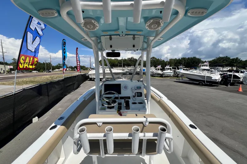 Slide: The Image of 2016 Sea Hunt Ultra 211 boat interior with steering console, docked at a marina. - 33