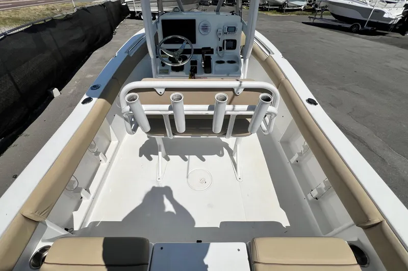 Slide: The Image of 2016 Sea Hunt Ultra 211 boat interior with beige seating and rod holders. - 36