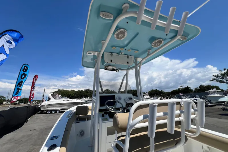 Slide: The Image of 2016 Sea Hunt Ultra 211 boat with T-top, displayed at a boat sale event. - 37