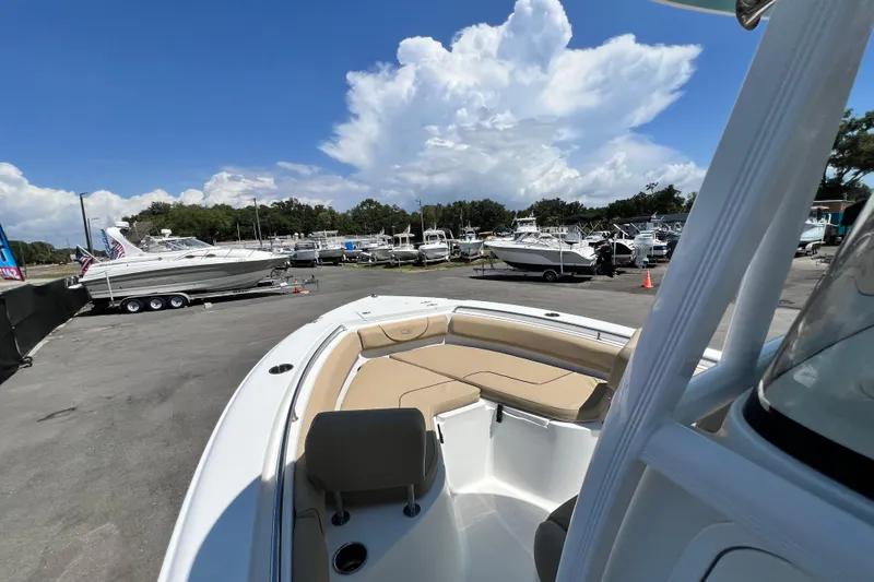 Slide: The Image of 2016 Sea Hunt Ultra 211 boat docked at a marina under a cloudy sky. - 39