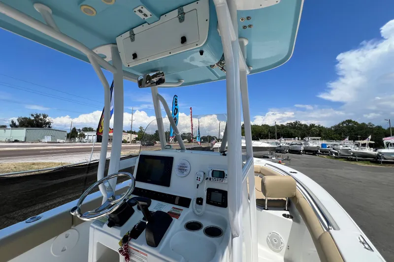 Slide: The Image of 2016 Sea Hunt Ultra 211 boat cockpit with steering wheel and navigation equipment. - 41