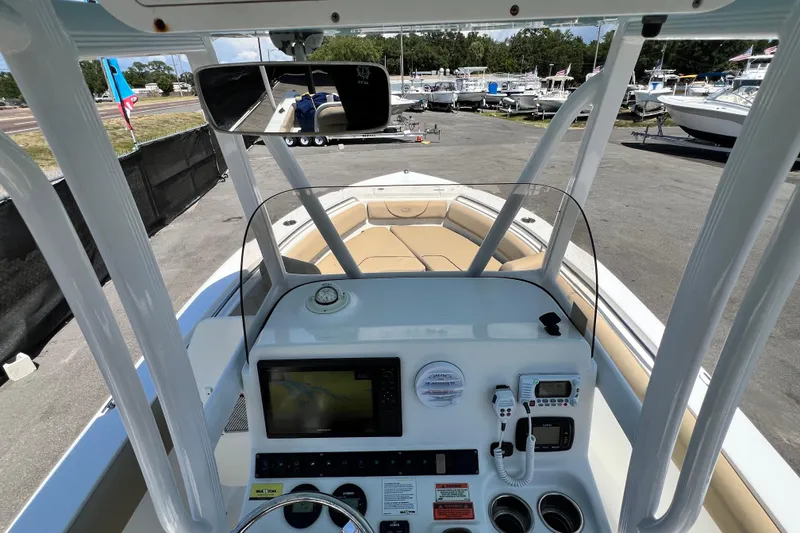 Slide: The Image of 2016 Sea Hunt Ultra 211 boat dashboard with navigation equipment and seating area. - 43